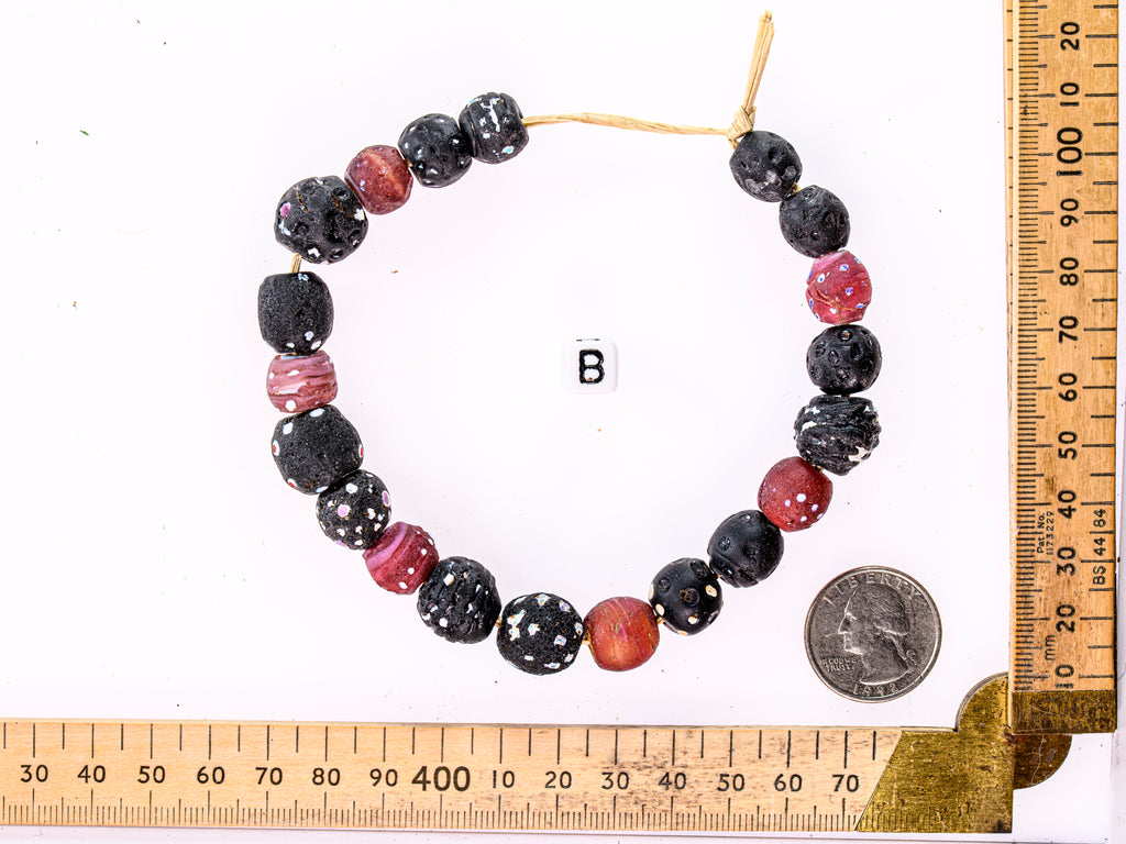 A Mixed Strand of Antique Venetian African Trade Black Eye "Skunk" and White Heart Beads