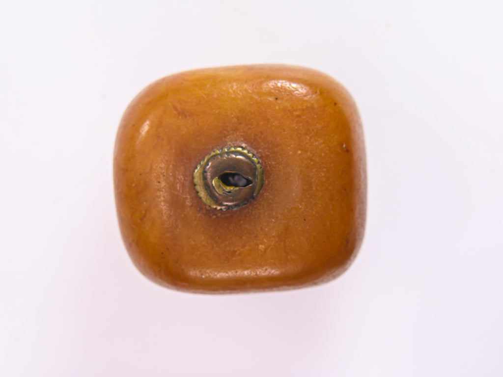 A Very Large Antique Natural Pressed Baltic Amber Capped Bead From the African Trade